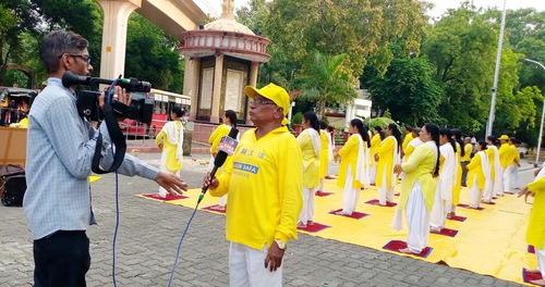 A cameraman for a YouTube channel interviews a practitioner.