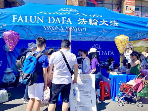 Visitors learn about Falun Gong during the celebration on September 17, 2023.