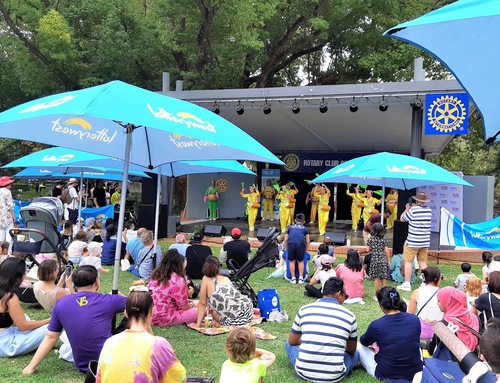 Practitioners perform a waist drum dance onstage at the Hyde Park Festival.