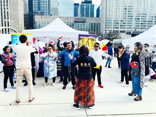 People learn the Falun Dafa exercises during the festival.