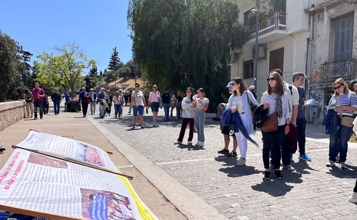 People who visited the Acropolis read the posters and learned about the 25-year-long persecution that is still happening in China.