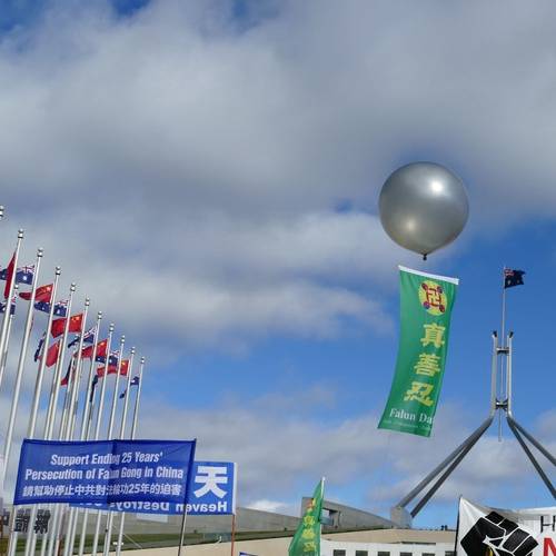 A colorful banner reading “Truthfulness, Compassion, Forbearance” flew in the sky during the protest outside the Parliament House on June 17.