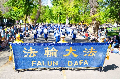 Spectators cheer the Falun Dafa entry in the 111th UC Davis Picnic Day Parade on April 12.